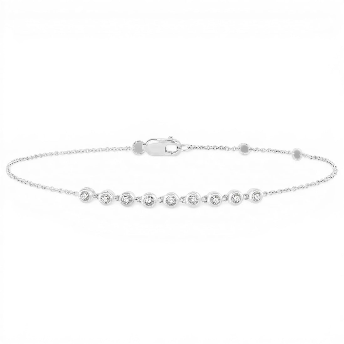 0.19 ctw Petite Bezel White Diamond 10K White Gold Link Bracelet: Exuding opulence and grace, this elegant Bezel bracelet featuring White Diamond is crafted for the distinguished. Showcasing the gems in a Bezel arrangement, the bracelet consists of 1.8 grams of 10K 