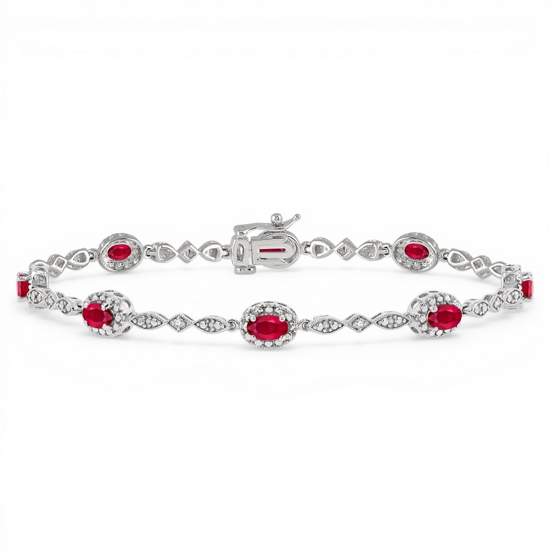 5x3 mm Oval Ruby and 0.05 ctw Diamond 14K White Gold Bracelet: Exuding opulence and grace, this elegant Halo bracelet featuring Ruby, White Diamond is crafted for the distinguished. Showcasing the gems in a Halo arrangement, the bracelet consists of 6.05 grams of