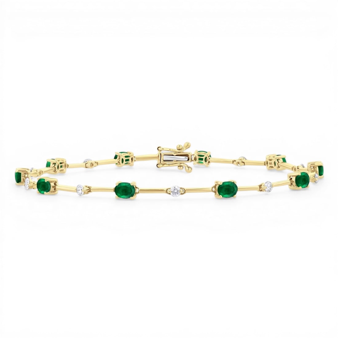 4x3mm Oval Emerald and 0.32 ctw Diamond 10K Yellow Gold Bracelet: An exquisite masterpiece of haute joaillerie, this magnificent Bar bracelet featuring Emerald, White Diamond is a true treasure. Showcasing the gems in a Bar arrangement, the bracelet consists of 3.15