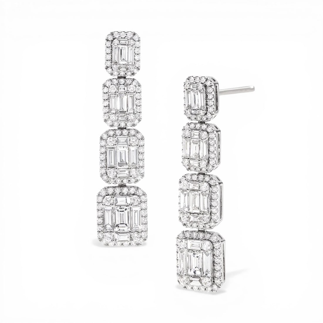 Empress 5.05 ctw Graduating Baguette Diamond 18K White Gold Drop Earrings: Captured in a moment of brilliance, this exquisite Graduating Baguette Drop pair of earrings featuring White Diamonds speaks to the connoisseur. Securely held in a classic Cluster design, the earrings