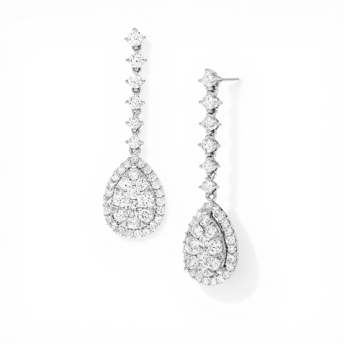 3.91 ctw White Diamond 18K White Gold Earrings: Captured in a moment of brilliance, this breathtaking Fiori Pear Drop Cluster pair of earrings featuring Natural Diamonds speaks to the connoisseur. Expertly mounted in a Drop/Cluster setting, the ear