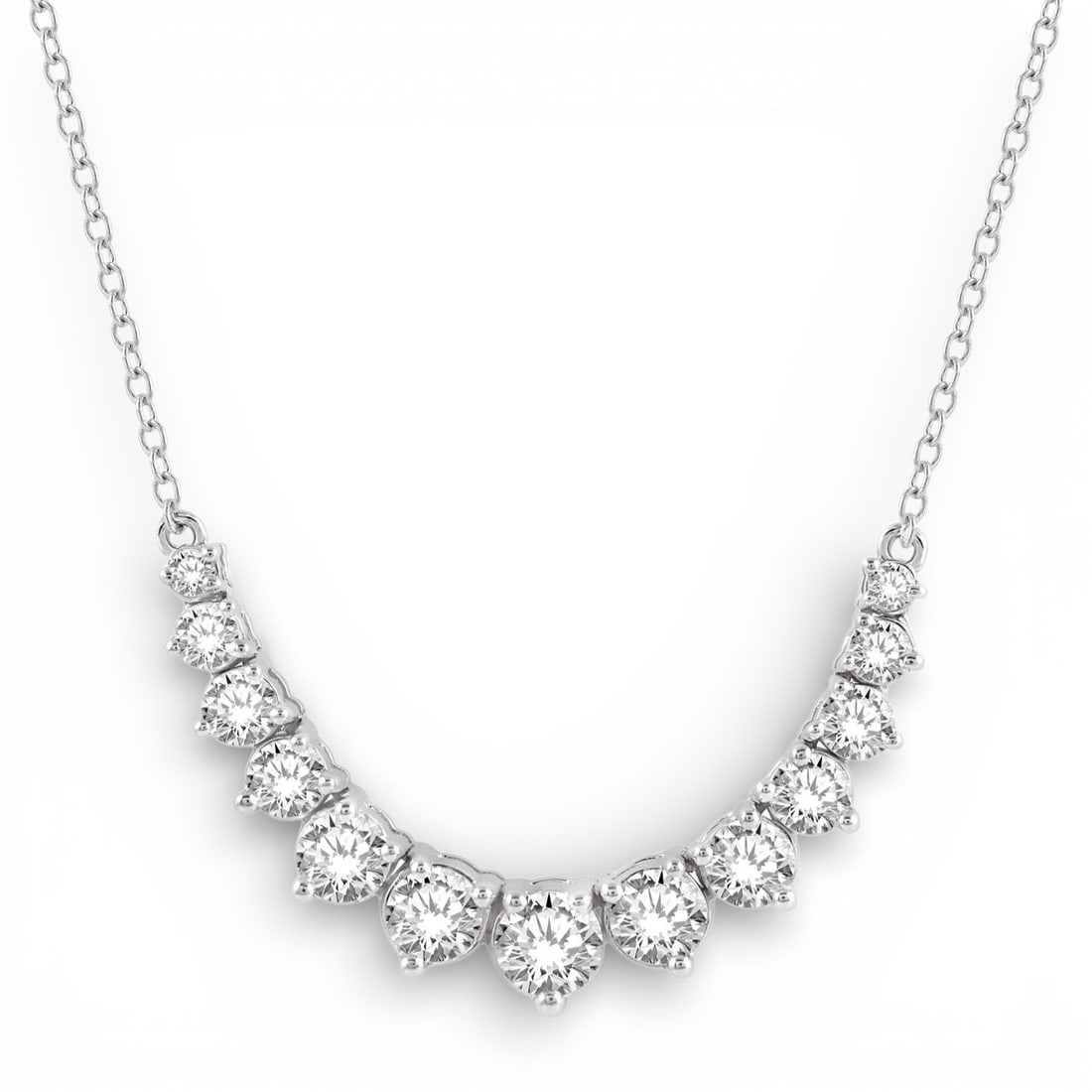 1.0 ctw Graduated Diamond Smile 14K White Gold Necklace: An exquisite masterpiece of haute joaillerie, this magnificent Smile necklace featuring White Diamond is a true treasure. Showcasing the gems in a Graduated Line arrangement, the necklace consists of 