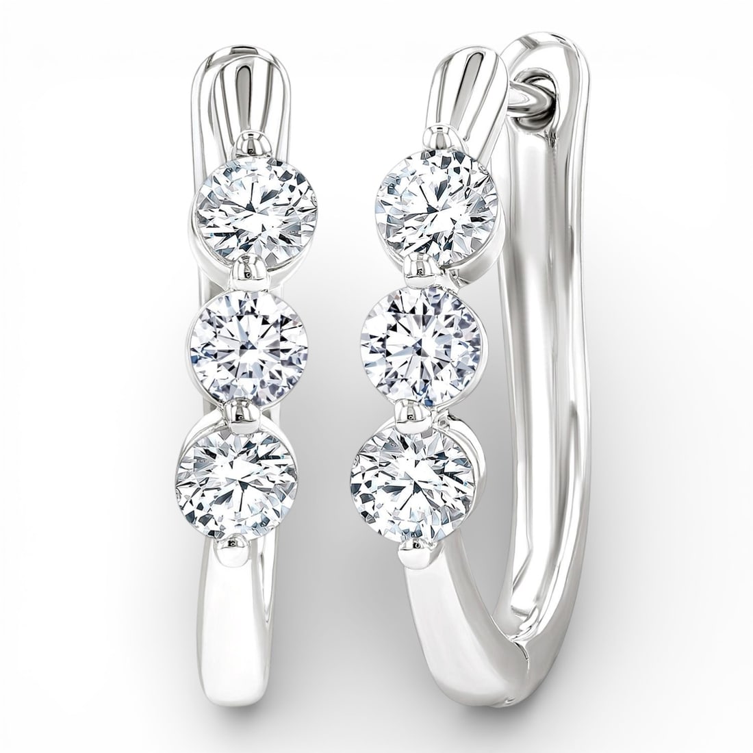 0.76 ctw Three-Stone Diamond 14K White Gold Hoop Earrings: Defining modern elegance, this stunning Three-Stone pair of earrings featuring Natural Diamonds captures the essence of style. The gemstones are nestled within a Three-Stone framework, supported by a 