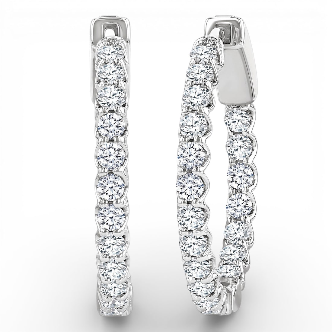 1.03 ctw White Diamond Inside-Out 14K White Gold Hoop Earrings: A vision of luxury, this elegant Inside-Out Hoop pair of earrings featuring White Diamond defines sophistication. The gemstones are nestled within a Shared Prong framework, supported by a substantial 