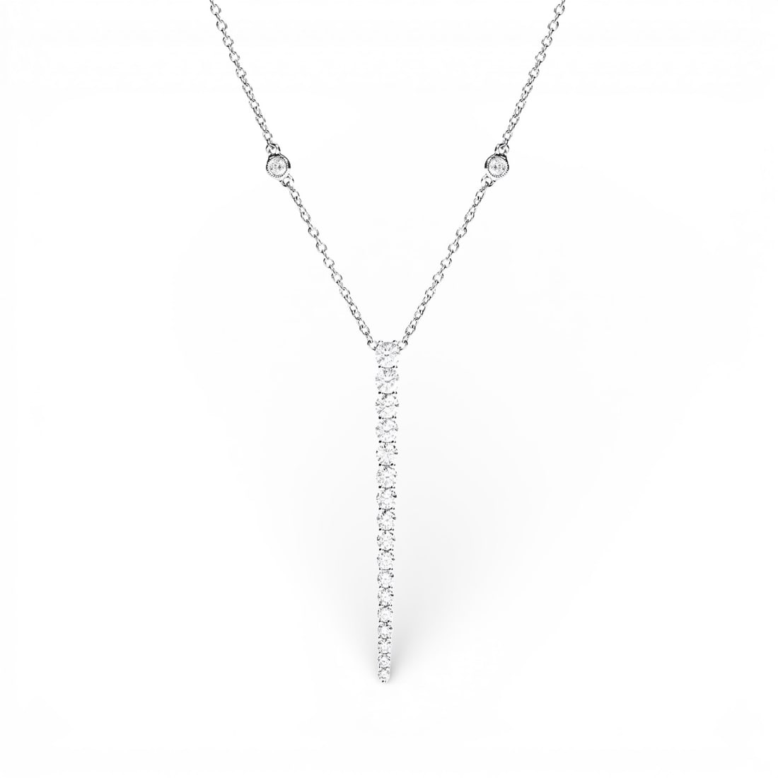 1.35 ctw Diamond 18K White Gold Pendant Necklace: Timeless and sophisticated, this breathtaking Graduating Necklace featuring Natural Diamonds radiates enduring beauty. Securely held in a classic Lariat design, the necklace is forged from 1.75 grams 