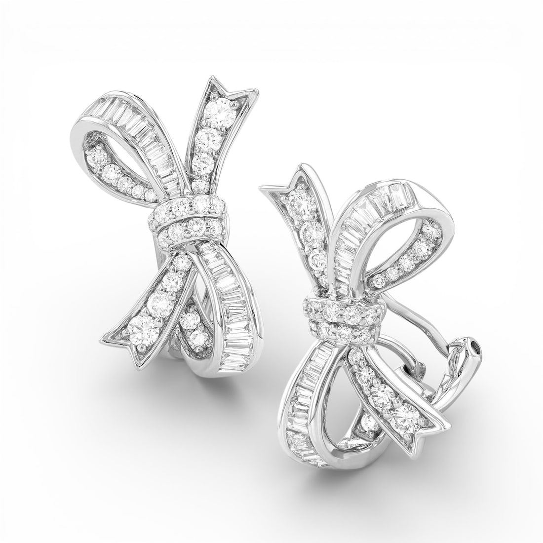 1.26 ctw White Diamond Midjourney Bow Tie 18K White Gold Earrings: An exquisite masterpiece of haute joaillerie, this breathtaking Bow Tie pair of earrings featuring White Diamond is a true treasure. Showcasing the gems in a Cluster arrangement, the earrings consists