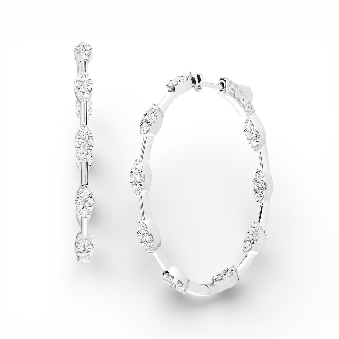 1.96 ctw White Diamond Fiori Cluster Hoop 18K White Gold Earrings: An exquisite masterpiece of haute joaillerie, this breathtaking Fiori Cluster Hoop pair of earrings featuring White Diamond is a true treasure. Crafted with precision, the Cluster setting is seamlessl