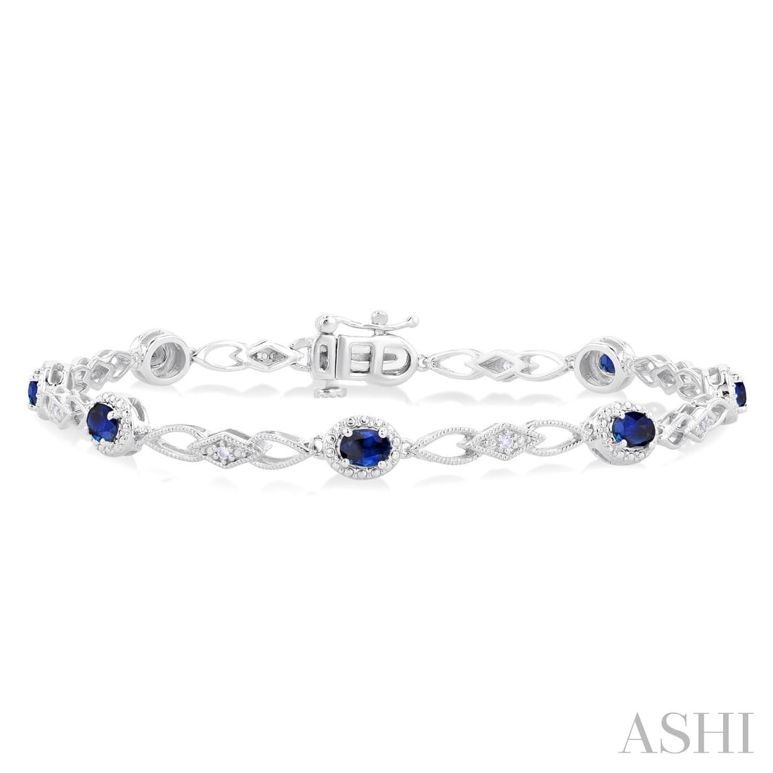 4x3mm Oval Blue Sapphire and 0.06 ctw Diamond 10K White Gold Bracelet: Rare and radiant, this exquisite Fancy Link bracelet featuring Blue Sapphire, White Diamond offers a touch of the extraordinary. Showcasing the gems in a Cluster arrangement, the bracelet consists of 