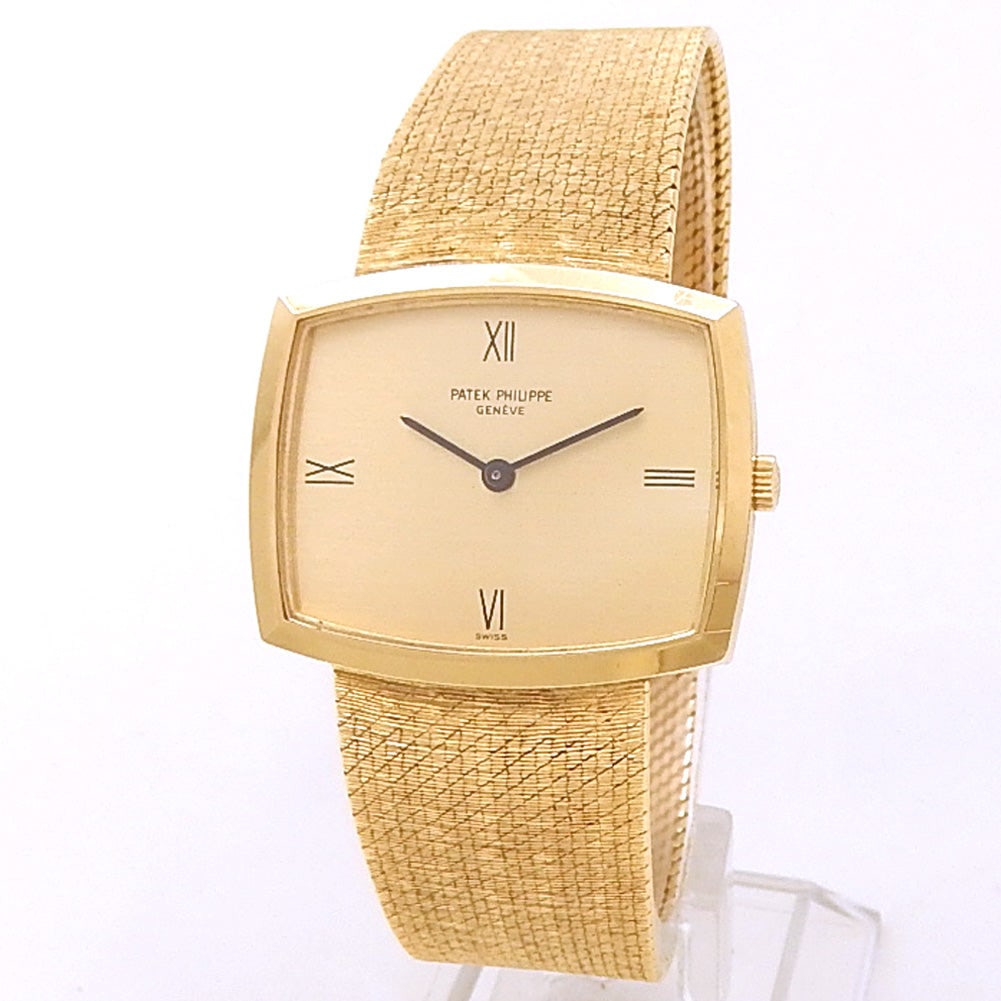 Patek Philippe Vintage Gondolo 3528/1J 18k Yellow Gold Champagne Dial: The Patek Philippe Vintage Gondolo, Reference 3528/1J, is a superb expression of classic elegance and mid-century refinement. Crafted in exquisite 18k yellow gold, this iconic rectangular timepiece fe