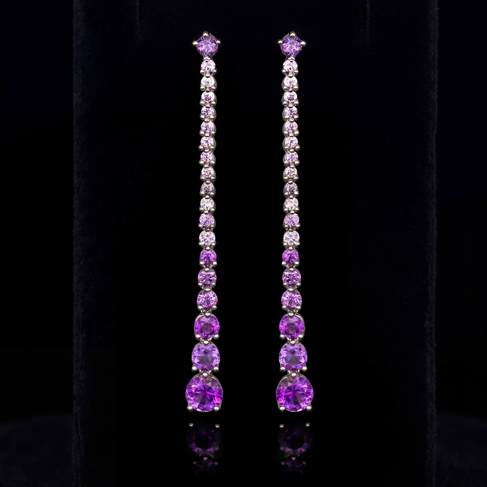 2.1 ctw Amethyst and Pink Sapphire Platinum Earrings: Retail Value: $1,800 A testament to superior craftsmanship, this exquisite Vapour pair of earrings featuring Amethyst, Pink Sapphire is unparalleled. A detailed Linear Drop gallery secures the stones,