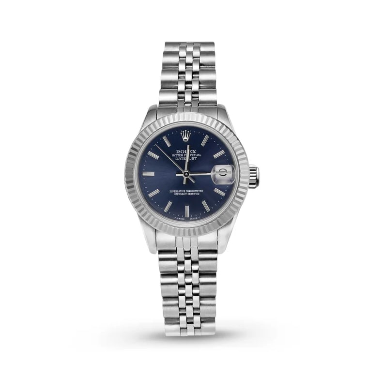 Rolex Datejust 6917 26mm Stainless Steel Silver Dial: The Rolex Datejust, Reference 6917, is a timeless classic. Crafted in stainless steel with a striking fluted yellow gold bezel, this 26mm timepiece displays a refined silver dial accented by lumin