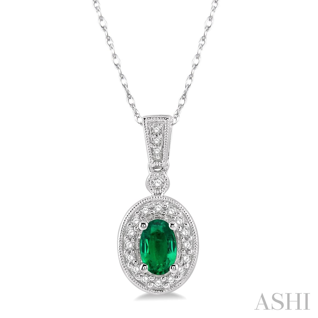 6x4mm Oval Emerald and 0.12 ctw Diamond 14K White Gold Pendant: Exuding opulence and grace, this elegant Halo pendant featuring Emerald, White Diamond is crafted for the distinguished. Showcasing the gems in a Halo arrangement, the pendant consists of 2.1 grams of