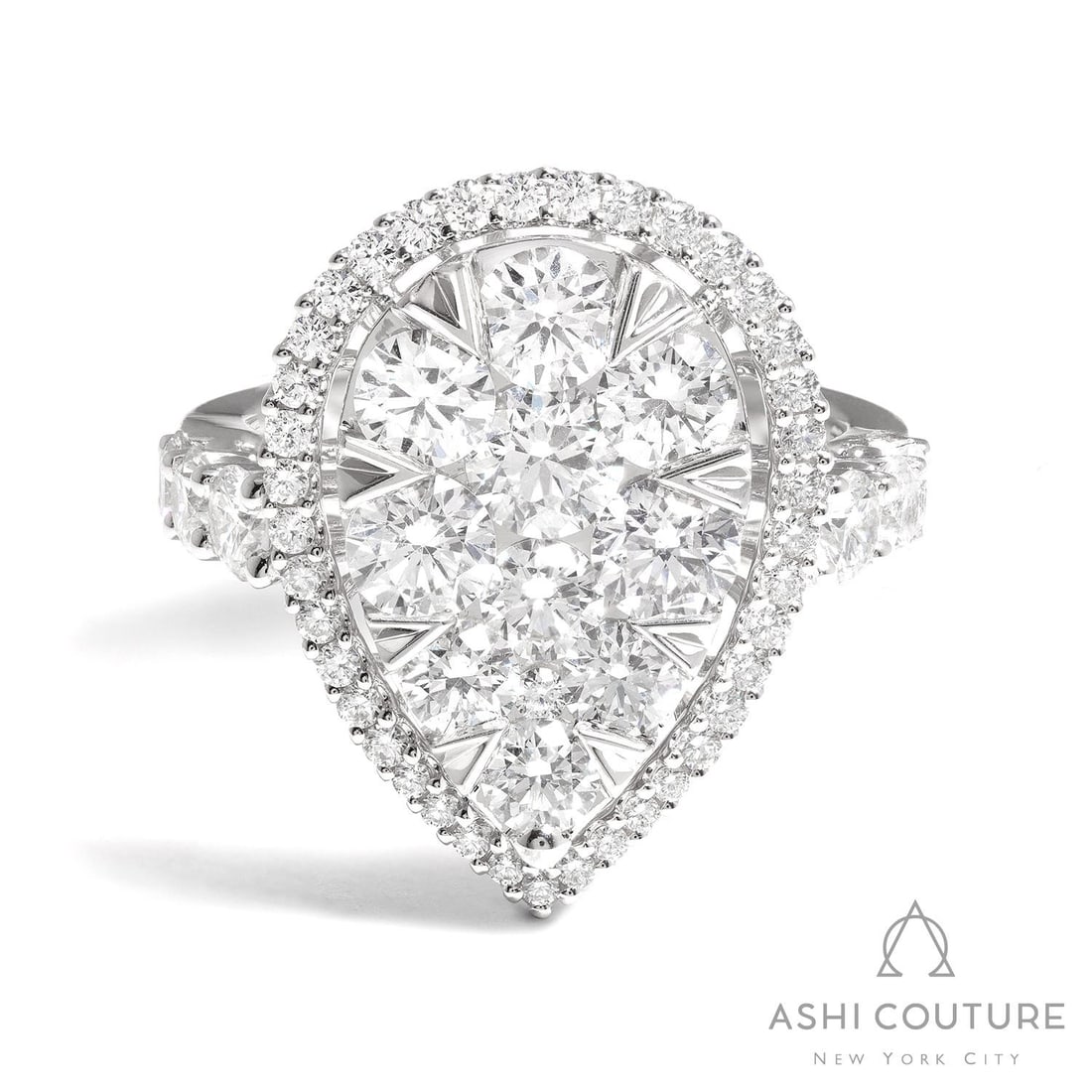 3.21 ctw Diamond 18K White Gold Cocktail Ring: Defining modern elegance, this magnificent Fiori Pear Classic Cluster ring featuring White Diamond captures the essence of style. Expertly mounted in a Halo setting, the ring is crafted in 7.2 grams o