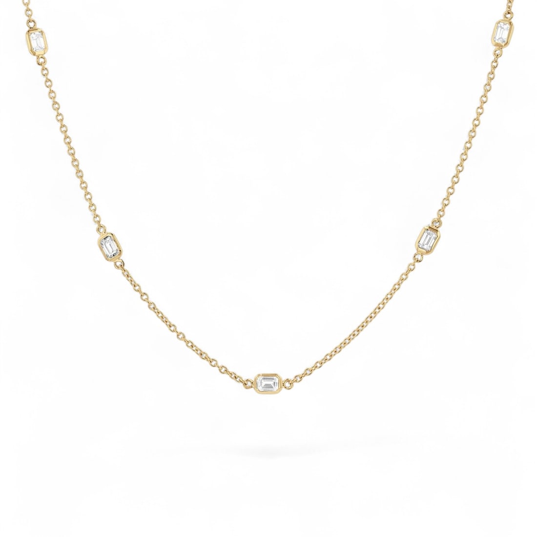 1.05 Ctw Emerald Cut Station White Diamond Modern 14K Yellow Gold Necklace - Certified: Captured in a moment of brilliance, this stunning Emerald Cut Station necklace featuring Natural Diamonds speaks to the connoisseur. Expertly mounted in a Bezel setting, the necklace is crafted in 2.6