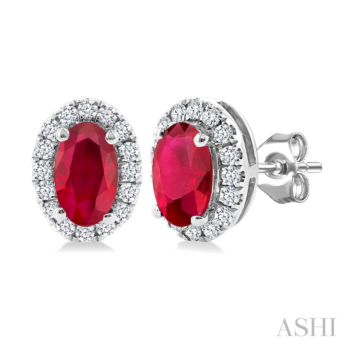 5x3mm Oval Ruby and 0.14 ctw Diamond 10K White Gold Earrings: A symphony of light and color, this stunning Halo pair of earrings featuring Ruby, White Diamond embodies the pinnacle of luxury. Securely held in a classic Halo design, the earrings are forged from 0