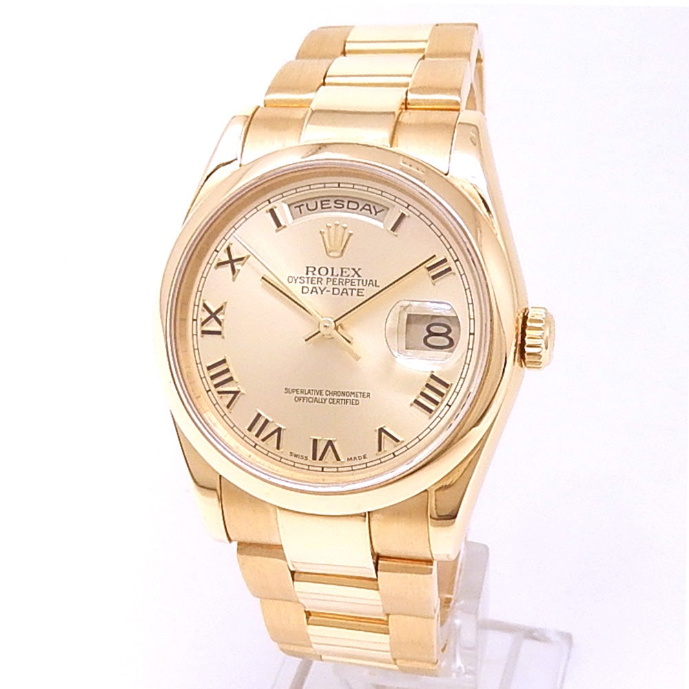 Rolex Day-Date 118208 18k Yellow Gold Champagne Dial: The Rolex Day-Date, Reference 118208, is an icon of prestige and refinement. Crafted in sumptuous 18k yellow gold, this timepiece features a radiant Champagne dial, exuding timeless elegance. The