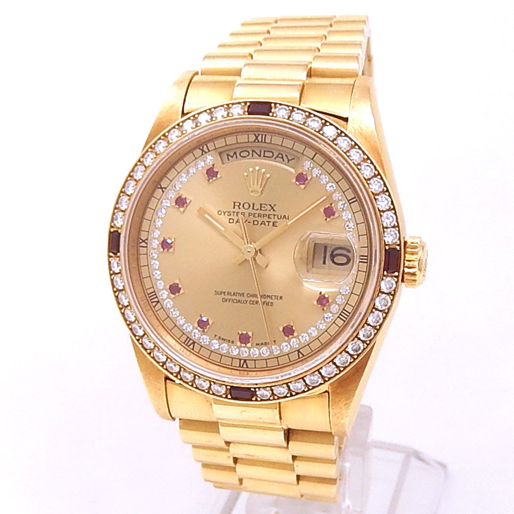 Rolex Day-Date 18378 18k Yellow Gold President Diamond Ruby Champagne Dial: The Rolex Day-Date, Reference 18378, is a radiant expression of prestige and refinement. Crafted in 18k Yellow Gold, this distinguished timepiece features a sumptuous Champagne dial enriched with
