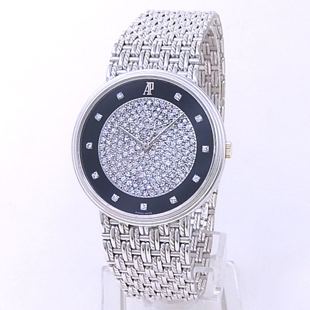 Audemars Piguet Vintage 56301BC 18k White Gold Black Diamond Pave Dial: The Audemars Piguet Vintage, Reference 56301BC, is an exquisite expression of twentieth-century elegance and high-jewelry craftsmanship. Sculpted from premium 18k white gold, the slim case features an