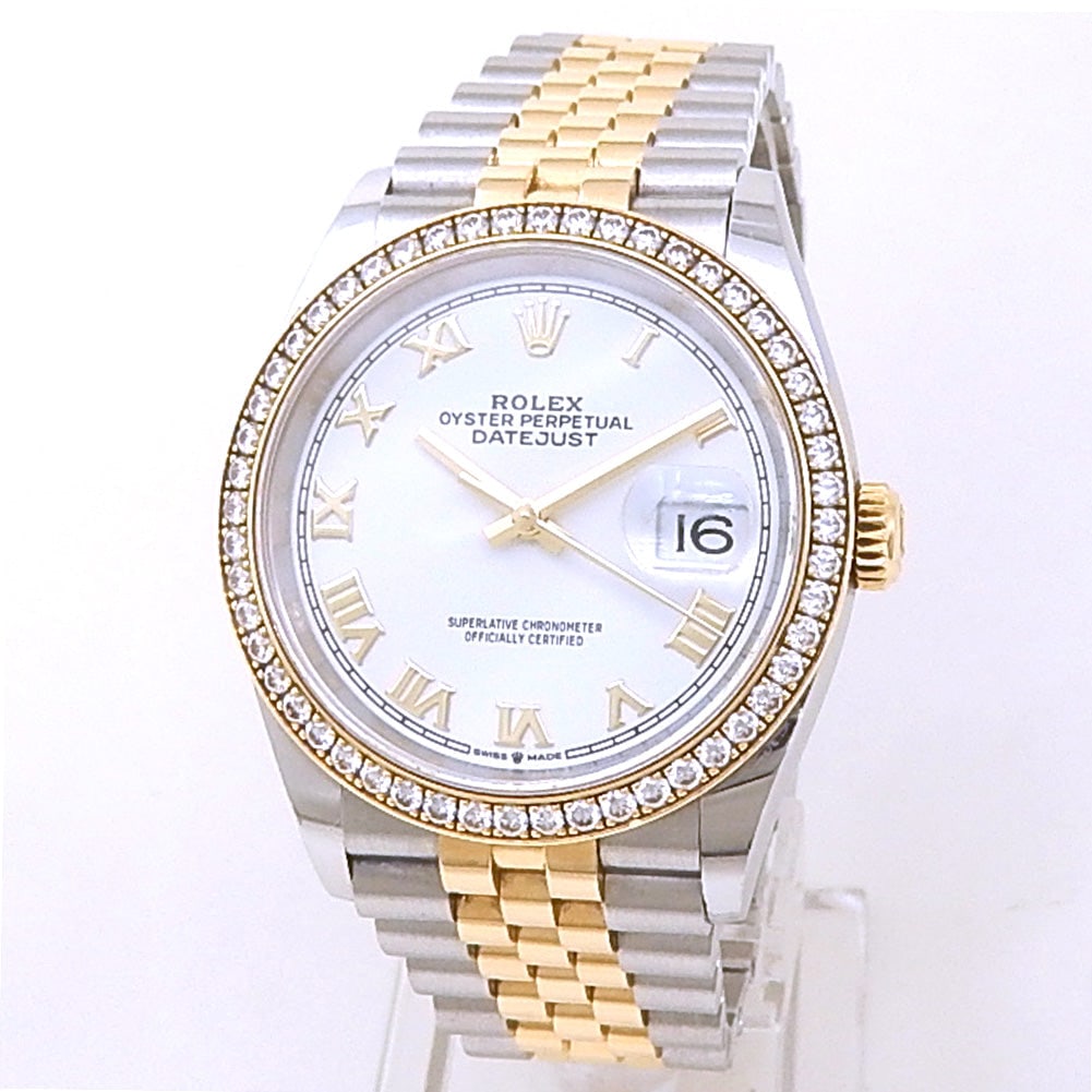 Rolex Datejust 126283RBR 18K Yellow Gold & Steel White Dial Diamond Bezel: The Rolex Datejust, Reference 126283RBR, is a radiant fusion of elegance and precision. Crafted in a resilient combination of 18k yellow gold and stainless steel, this 36mm timepiece presents a crisp 