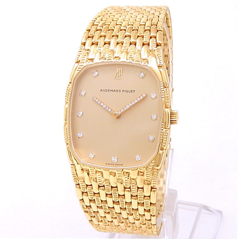 Audemars Piguet Cobra 18k Yellow Gold Champagne Diamond Dial: The Audemars Piguet Cobra is an iconic testament to the avant-garde design language of ultra-thin luxury. Crafted in a striking 18K yellow gold case, this vintage masterpiece features a radiant Champa