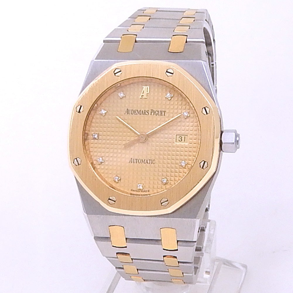 Audemars Piguet Royal Oak 18k Gold & Steel Champagne Diamond Dial: The Audemars Piguet Royal Oak captures the bold luxury of the iconic collection. Crafted in a combination of 18k yellow gold and stainless steel, this timepiece features a stunning Champagne dial