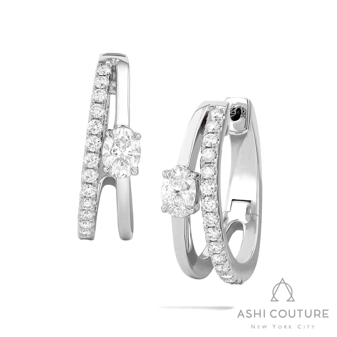 0.86 ctw Paradox Oval 2-Row Diamond 18K White Gold Earrings: Epitomizing grandeur, this breathtaking Paradox Oval 2-Row pair of earrings featuring White Diamond stands as a beacon of refined taste. Showcasing the gems in a Double-Band Suspension arrangement, th