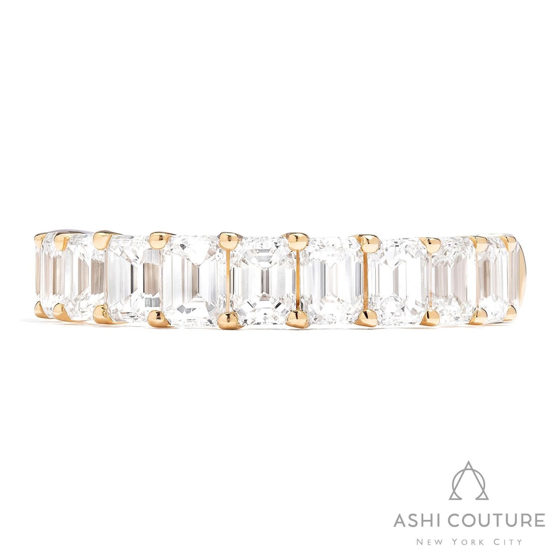 2.75 ctw Emerald Cut Diamond 18K Yellow Gold Band Ring: Epitomizing grandeur, this magnificent Duchess Halfway Band ring featuring White Diamond stands as a beacon of refined taste. Crafted with precision, the Shared Prong Band setting is seamlessly integr