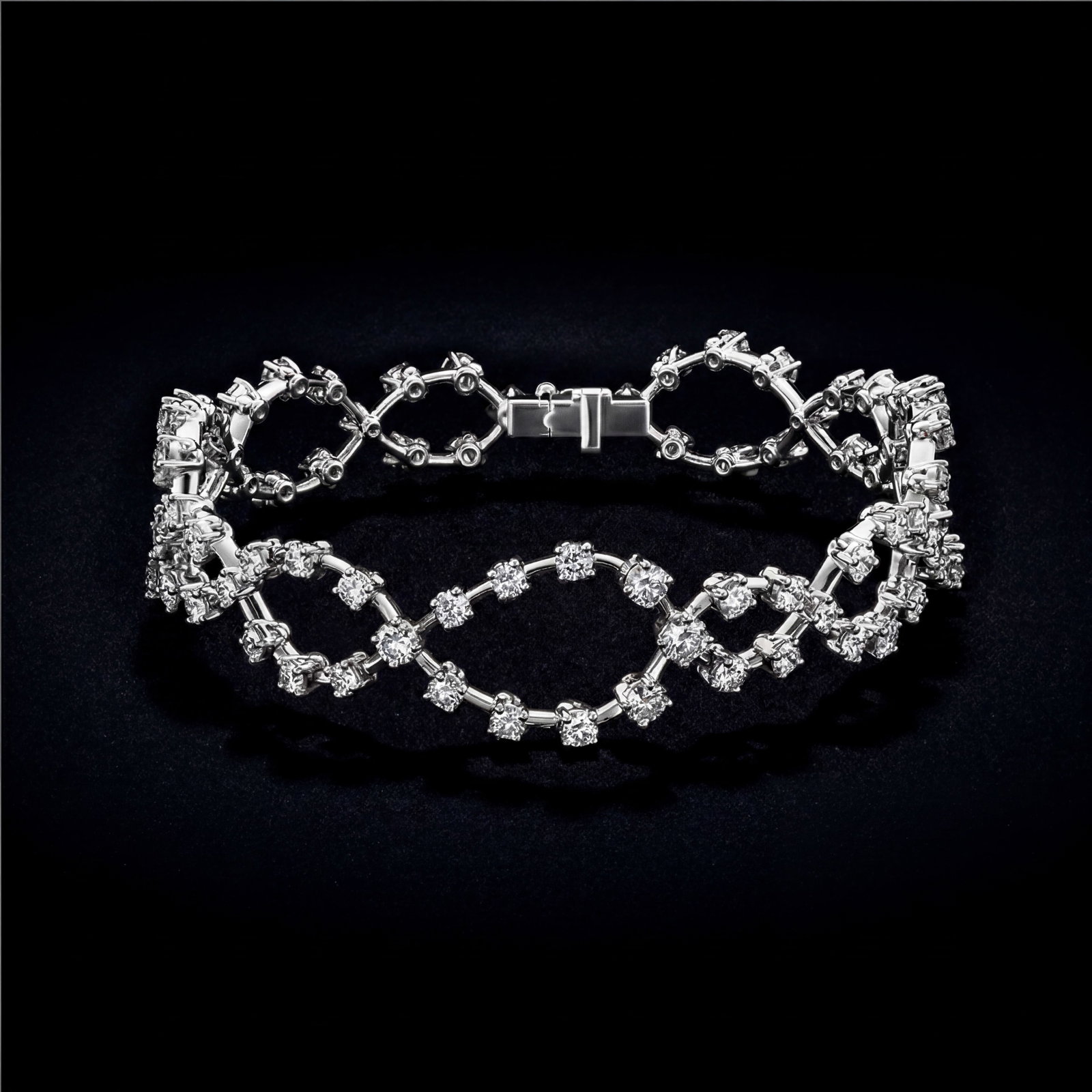 6.4 ctw Round Diamond Link Platinum Bracelet: Retail Value: $51,195 A symphony of light and color, this magnificent Link bracelet featuring White Diamond embodies the pinnacle of luxury. The gemstones are nestled within a Link/Prong Setting frame