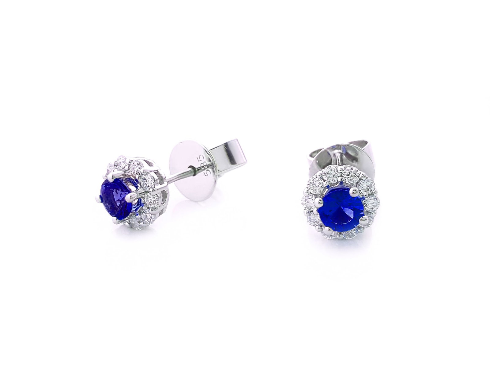 0.61ct Blue Sapphire and 0.29ctw Diamond 14K White Gold Stud Earrings: Rare and radiant, this elegant Halo pair of earrings featuring Blue Sapphire, White Diamond offers a touch of the extraordinary. Showcasing the gems in a Halo arrangement, the earrings consist of 1.06