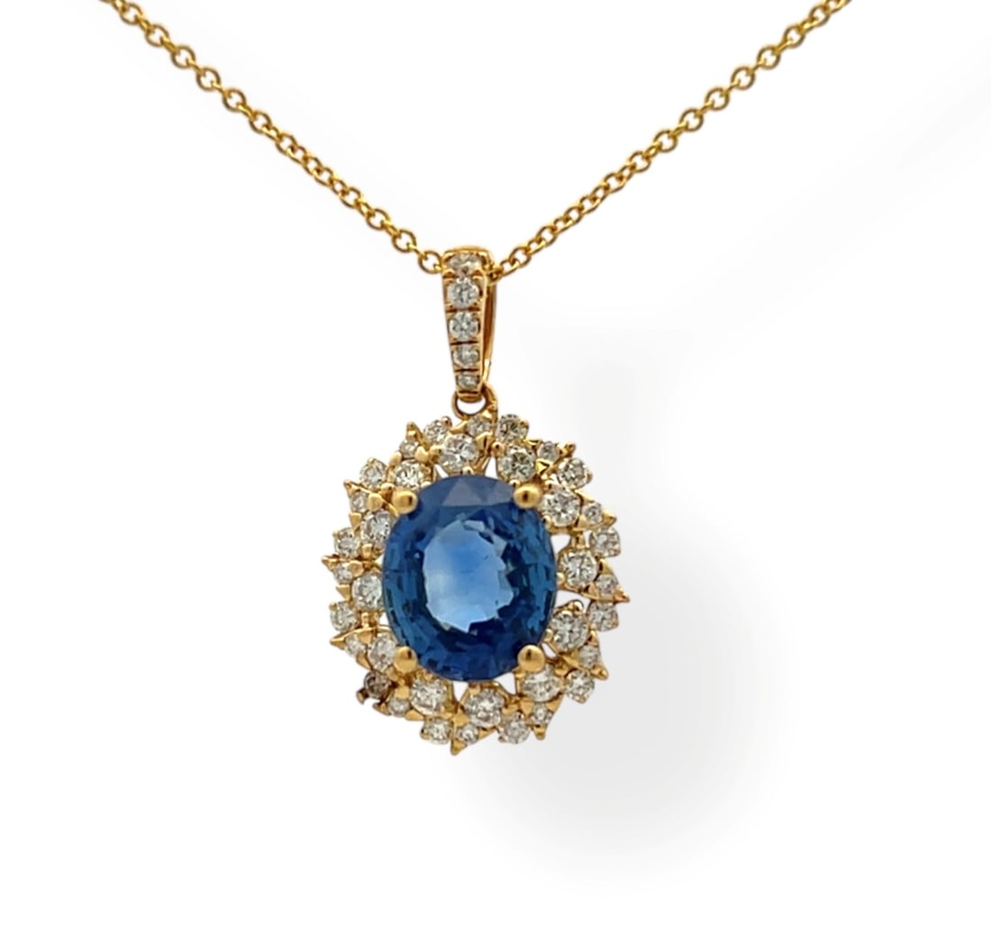 3.02ct Blue Sapphire and 0.46ctw Diamond 18K Yellow Gold Pendant: Rare and radiant, this breathtaking Halo pendant featuring Blue Sapphire, White Diamond offers a touch of the extraordinary. Crafted with precision, the Halo setting is seamlessly integrated into 1.45