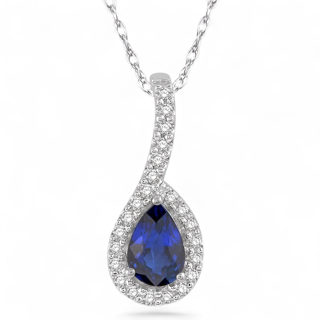 6x4 MM Blue Sapphire and 0.13 Ctw Pear Shape White Diamond Modern 10K White Gold Pendant - Certified: Epitomizing grandeur, this magnificent Pear Shape pendant featuring Natural Diamonds and Blue Sapphires stands as a beacon of refined taste. Crafted with precision, the Halo setting is seamlessly inte