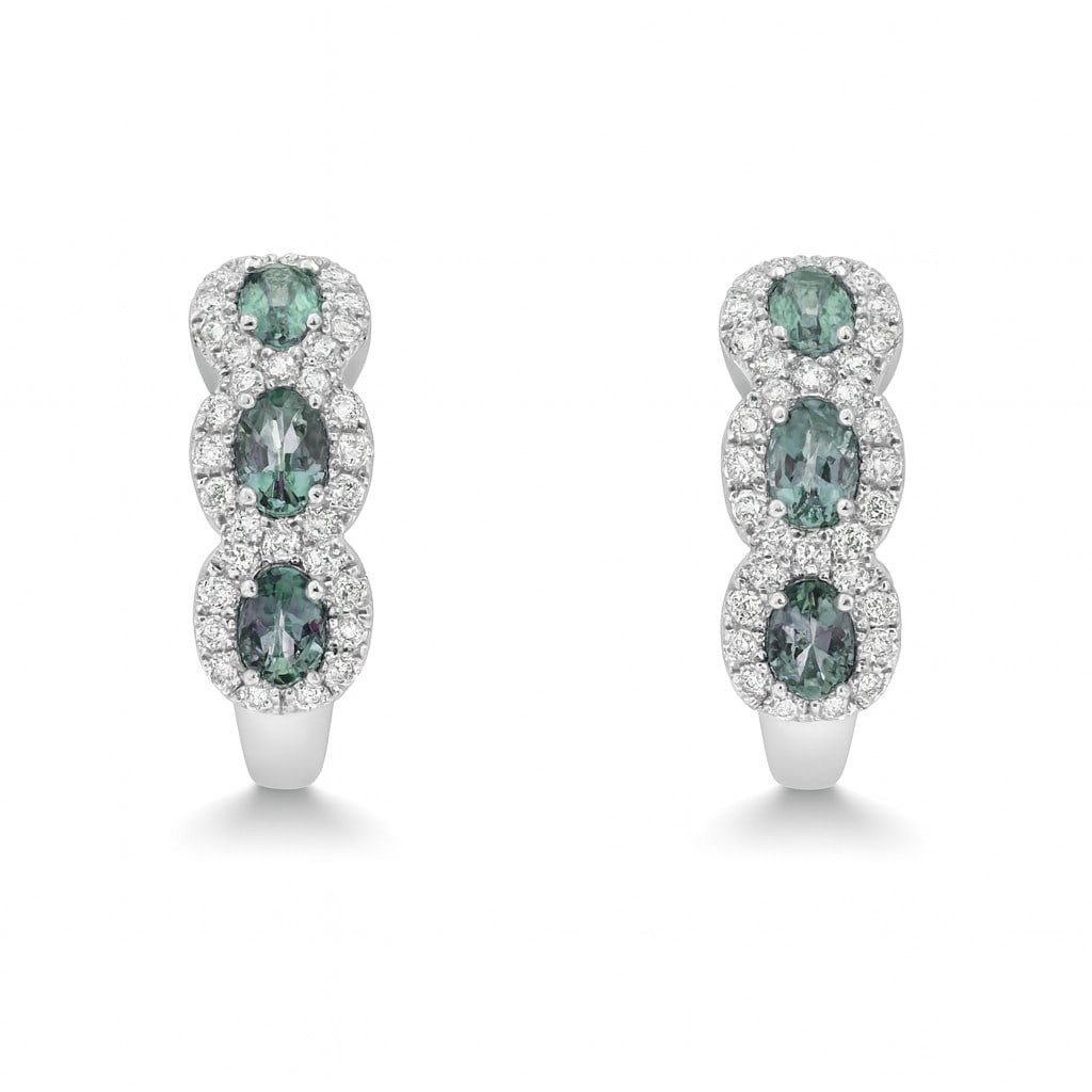 0.78ct Oval Alexandrite and 0.39ctw Diamond 14K White Gold Huggie Earrings: Exuding opulence and grace, this elegant Three-Stone Halo pair of earrings featuring Alexandrite, White Diamond is crafted for the distinguished. A detailed Three-Stone Halo gallery secures the stones
