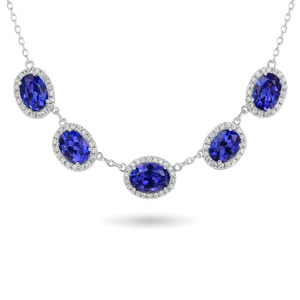 6.91ct Tanzanite and 0.98ctw Diamond 14K White Gold Necklace: A testament to superior craftsmanship, this magnificent Five-stone Mini necklace featuring Tanzanite, White Diamond is unparalleled. Showcasing the gems in a Halo arrangement, the necklace consists of