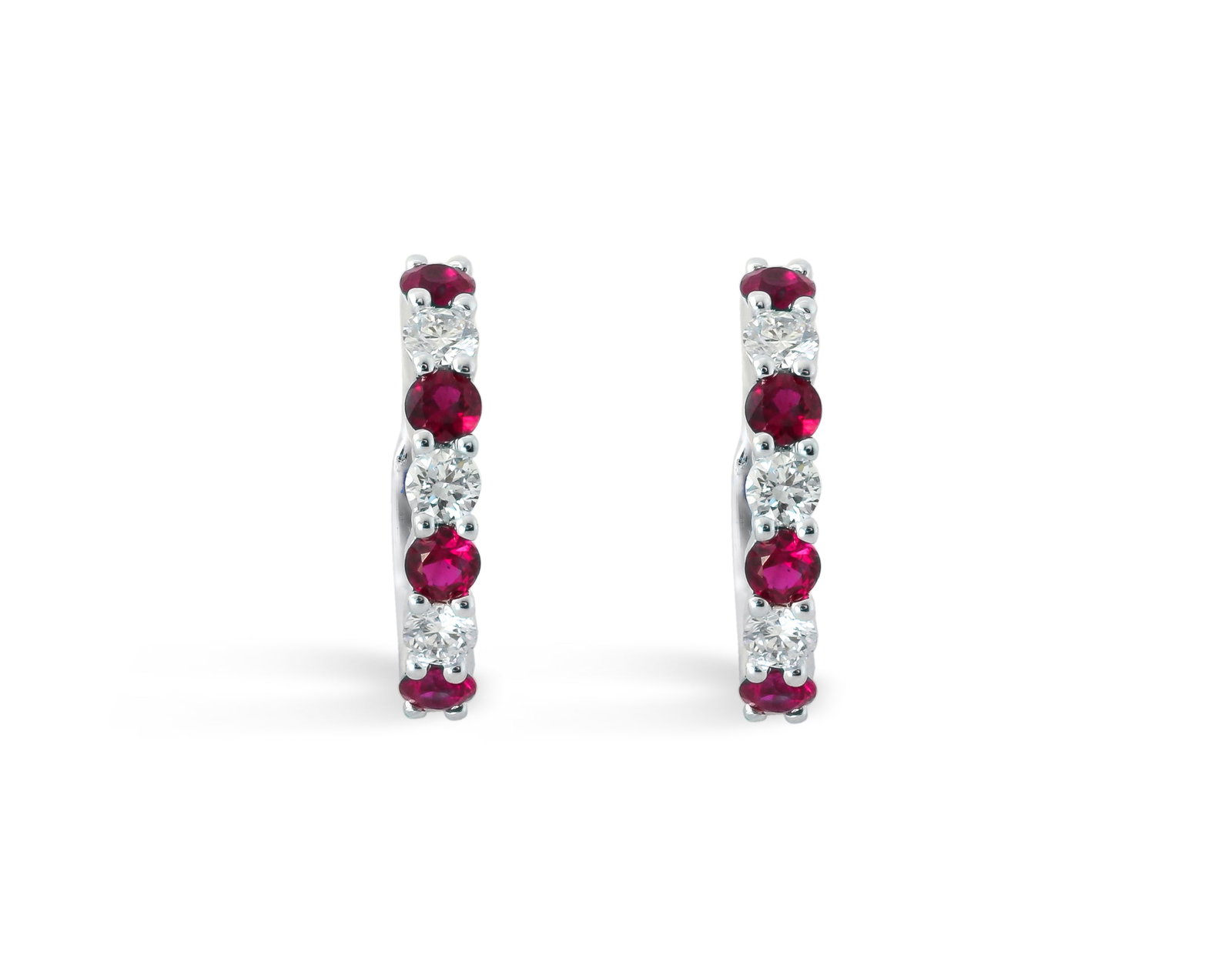 0.69ct Ruby and 0.38ctw Diamond 14K White Gold Huggies: A vision of luxury, this exquisite Alternating pair of earrings featuring Ruby, White Diamond defines sophistication. Expertly mounted in a Prong setting, the earrings are crafted in 1.99 grams of sol