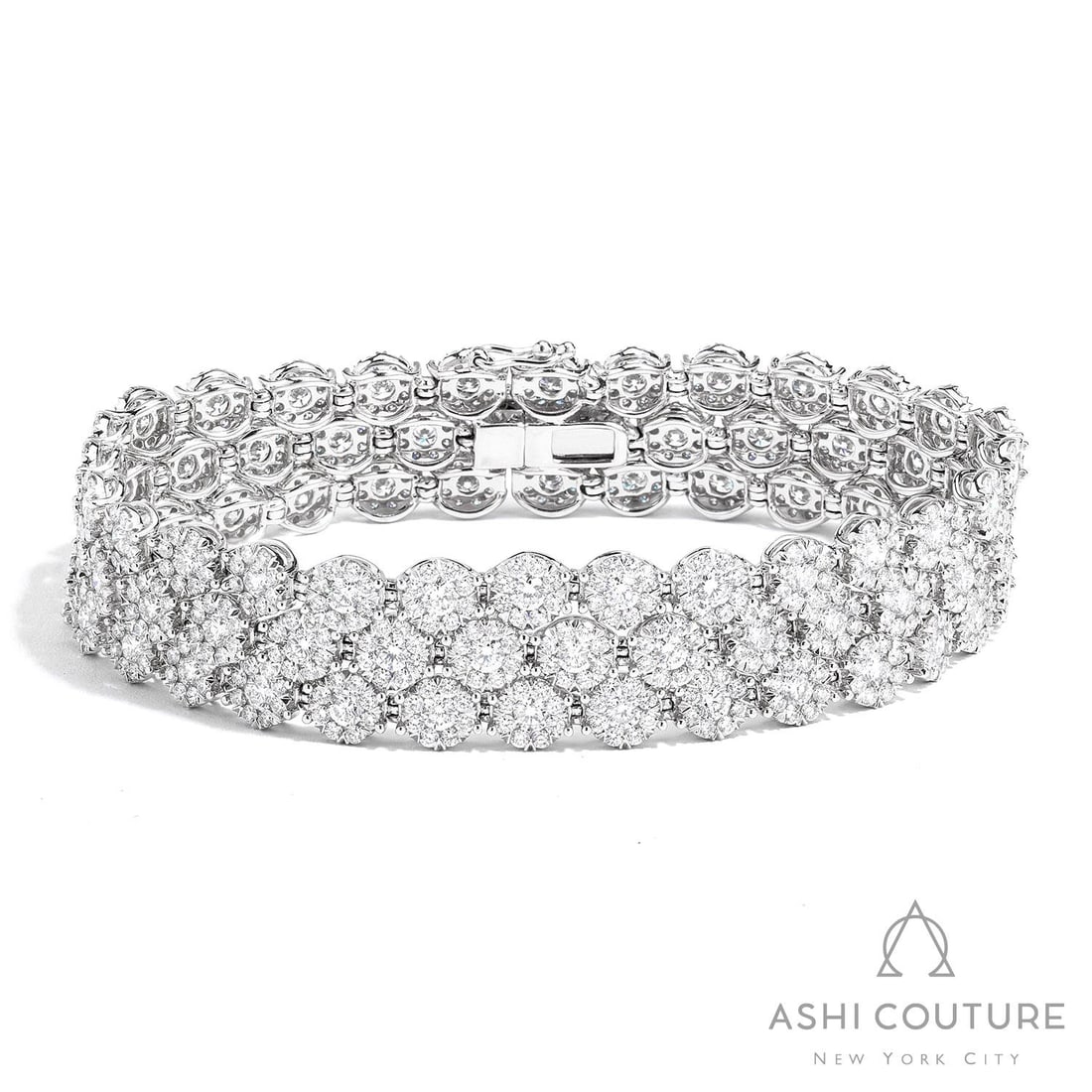 12.94 ctw Round White Diamond Three-Row Tennis Bracelet 18K White Gold: Retail Value: $66,255 Timeless and sophisticated, this magnificent Three-Row tennis bracelet featuring White Diamond radiates enduring beauty. Crafted with precision, the Cluster setting is seamlessly