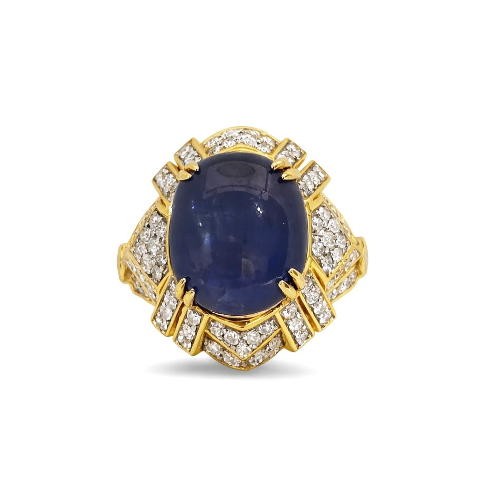 13.92ct Star Sapphire and 1.18ct Diamond 18K Yellow Gold Ring: A vision of luxury, this magnificent Oval Star Sapphire ring featuring Blue Sapphire, White Diamond defines sophistication. Expertly mounted in a Cluster setting, the ring is crafted in 10.4 g of soli