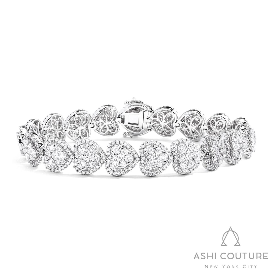 7.75 ctw Fiori Heart Diamond 18k White Gold Tennis Bracelet: Retail Value: $43,125 A vision of luxury, this exquisite Fiori Heart tennis bracelet featuring White Diamond defines sophistication. A detailed Cluster gallery secures the stones, rendered in 21.4 g o