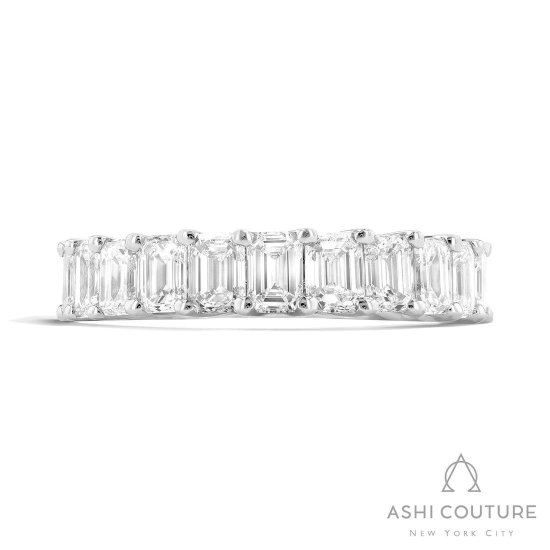 5.50 ctw Emerald Cut Diamond Eternity Band Platinum Ring: A symphony of light and color, this stunning Duchess Emerald Cut ring featuring White Diamond embodies the pinnacle of luxury. Expertly mounted in an Eternity Band setting, the ring is crafted in 6.0 