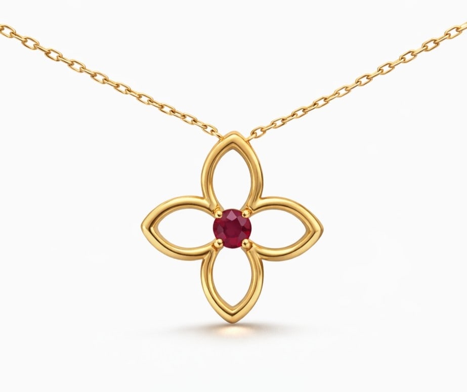 0.32ct Ruby Clover 14K Yellow Gold Pendant: Captured in a moment of brilliance, this exquisite Clover silhouette pendant featuring Ruby speaks to the connoisseur. Securely held in a classic Prong design, the pendant is forged from 3.11 grams of