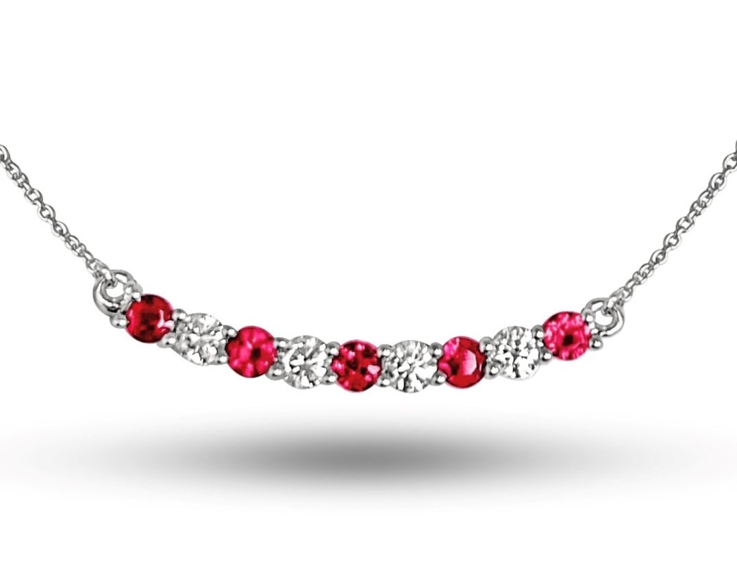 0.48ct Ruby and 0.33ctw Diamond 14K White Gold Pendant: Epitomizing grandeur, this elegant Alternating Curved pendant featuring Ruby, White Diamond stands as a beacon of refined taste. Crafted with precision, the Linear Bar Setting setting is seamlessly in