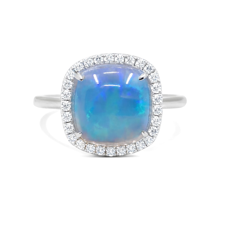 3.69ct Cushion Opal and 0.19ctw Diamond East-West Halo 14K White Gold Ring: Rare and radiant, this magnificent Halo ring featuring Opal, White Diamond offers a touch of the extraordinary. Showcasing the gems in a Halo arrangement, the ring consists of 3.89 grams of 14K White 