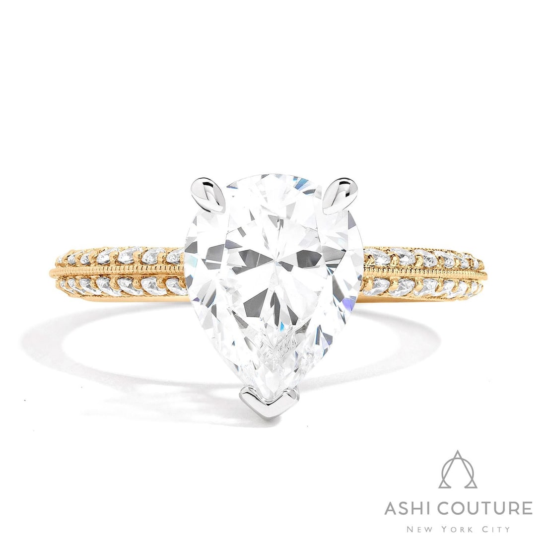 0.64 ctw White Diamond Knife-Edge 14K Yellow & White Gold Engagement Ring: A testament to superior craftsmanship, this breathtaking Knife-Edge Pear ring featuring White Diamond is unparalleled. A detailed Solitaire gallery secures the stones, rendered in 3.75 grams of lustro