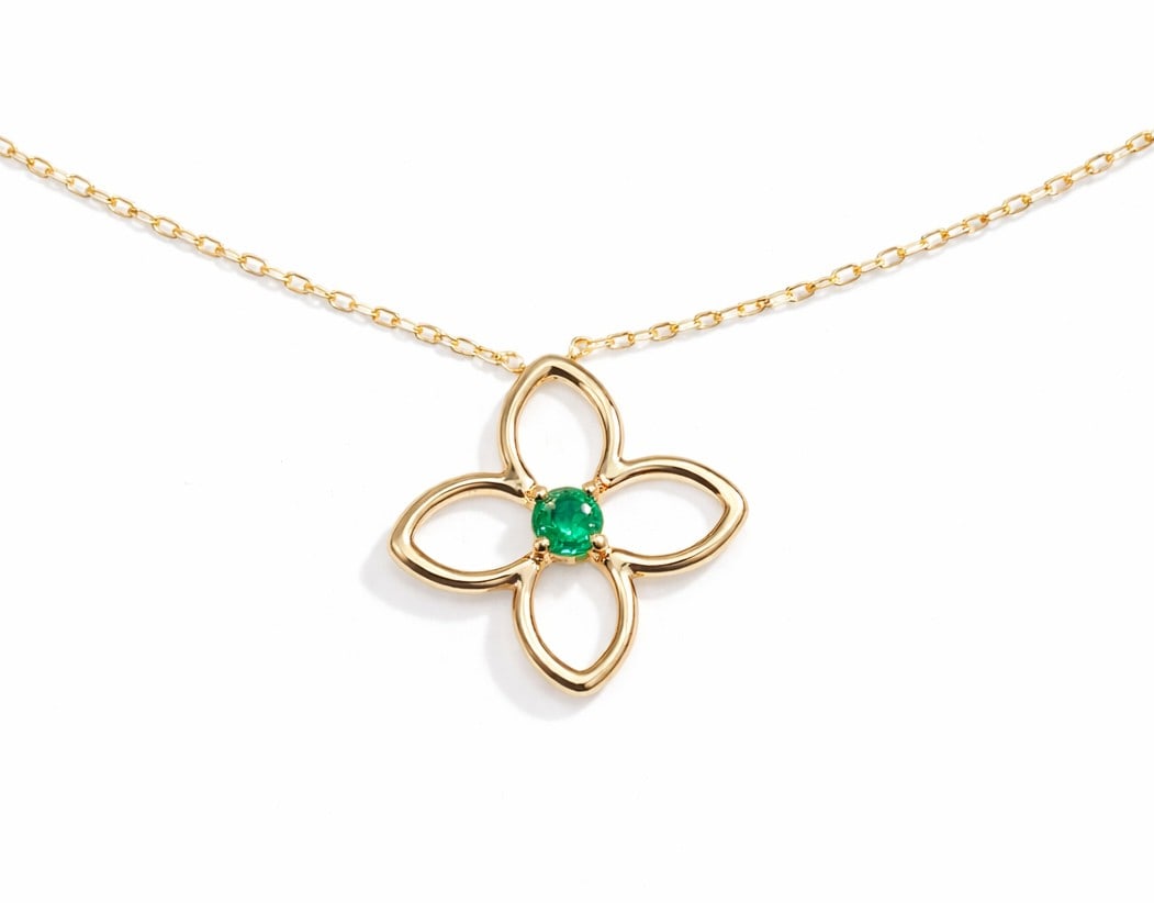 0.21ct Emerald Clover 14K Yellow Gold Pendant: An exquisite masterpiece of haute joaillerie, this elegant Clover pendant featuring Emerald is a true treasure. Crafted with precision, the Solitaire setting is seamlessly integrated into 3.2 grams of