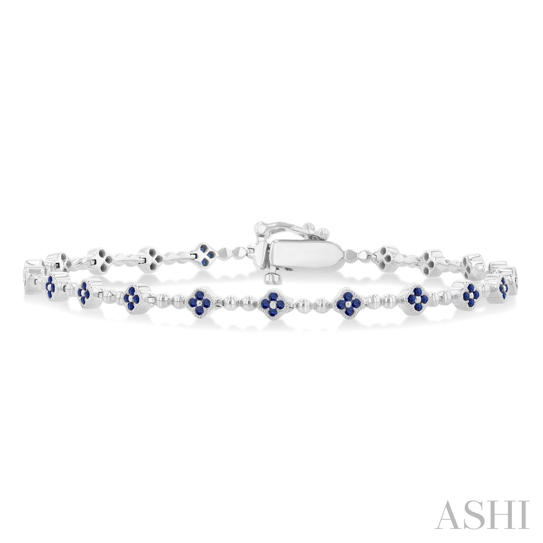 1mm Round Blue Sapphire Clover Link 14K White Gold Tennis Bracelet: Captured in a moment of brilliance, this exquisite Clover bracelet featuring Blue Sapphire speaks to the connoisseur. The gemstones are nestled within a Cluster framework, supported by a substantial 8