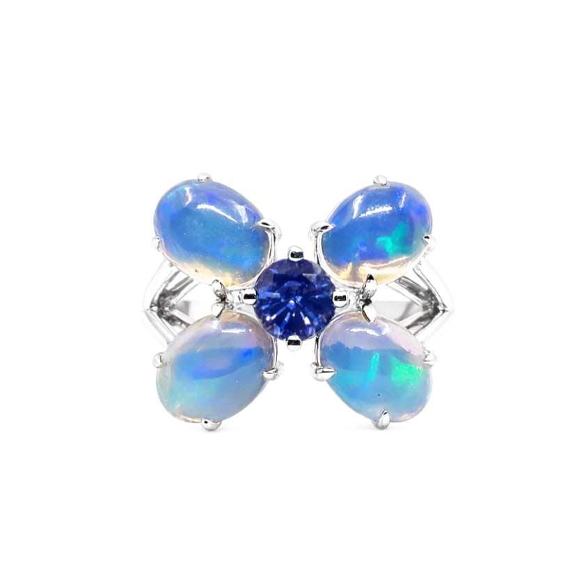 2.88ct Oval Opal and 0.57ctw Sapphire 14K White Gold Butterfly Ring: A symphony of light and color, this breathtaking Butterfly ring featuring Opal, Blue Sapphire embodies the pinnacle of luxury. Expertly mounted in a Cluster setting, the ring is crafted in 3.72 grams 