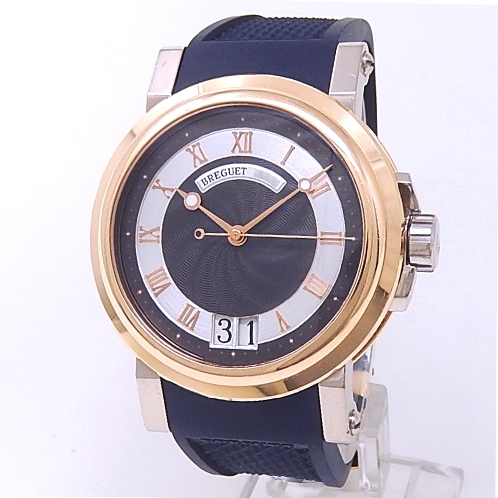 Breguet Marine Big Date 5817 18K Rose & White Gold Black and Silver Dial: The Breguet Marine Big Date, Reference 5817, is a superb blending of historical elegance and athletic luxury. Crafted from a refined pairing of 18K rose gold and 18K white gold, this watch features a 