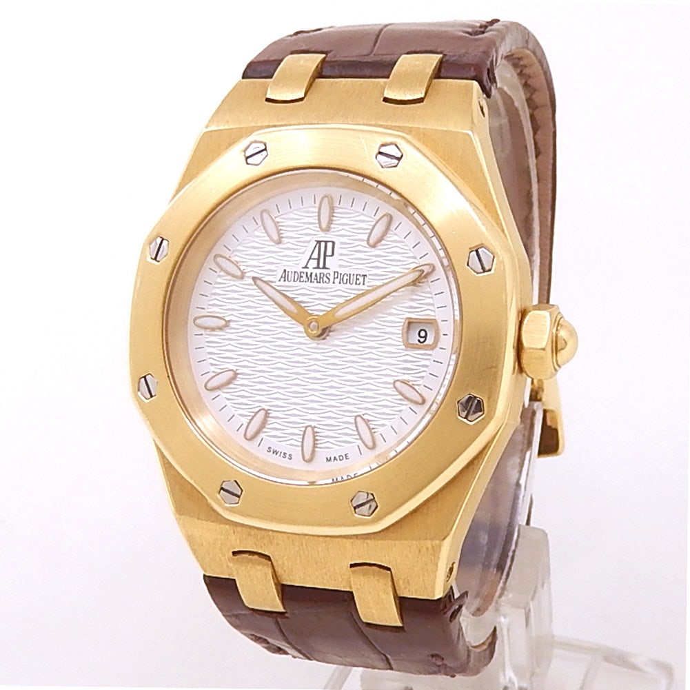 Audemars Piguet Royal Oak 67600BA 18k Yellow Gold Silver Dial: The Audemars Piguet Royal Oak, Reference 67600BA.OO.D090CR.01, represents a perfect harmony of iconic sporty heritage and refined luxury. Sculpted from lustrous 18k yellow gold, this ladies' timepiece