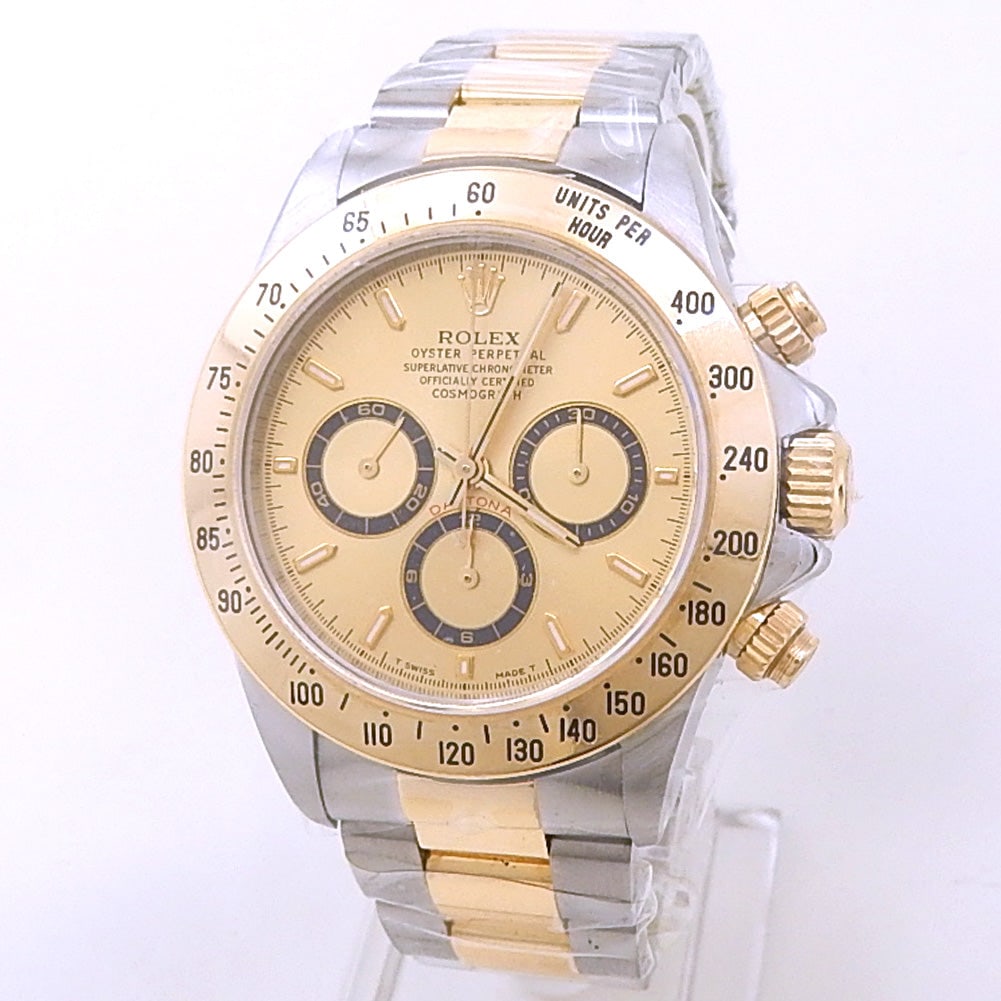 Rolex Daytona Zenith 16523 Steel & 18K Yellow Gold Champagne Dial: The Rolex Daytona "Zenith", Reference 16523, represents a legendary era of sports horology. Crafted in a striking combination of stainless steel and 18k yellow gold, this timepiece features a stunning