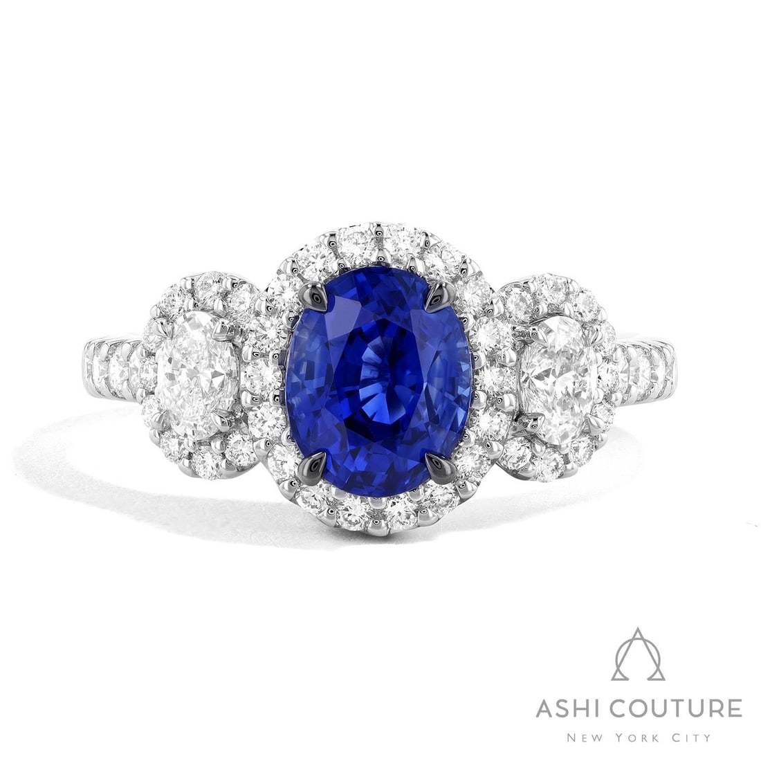 Oval Blue Sapphire and 1.02 ctw White Diamond 18K White Gold Ring: Retail Value: $24,165 A vision of luxury, this exquisite Three-Stone ring featuring Blue Sapphire, White Diamond defines sophistication. Showcasing the gems in a Three-Stone (with Halo) arrangement, t
