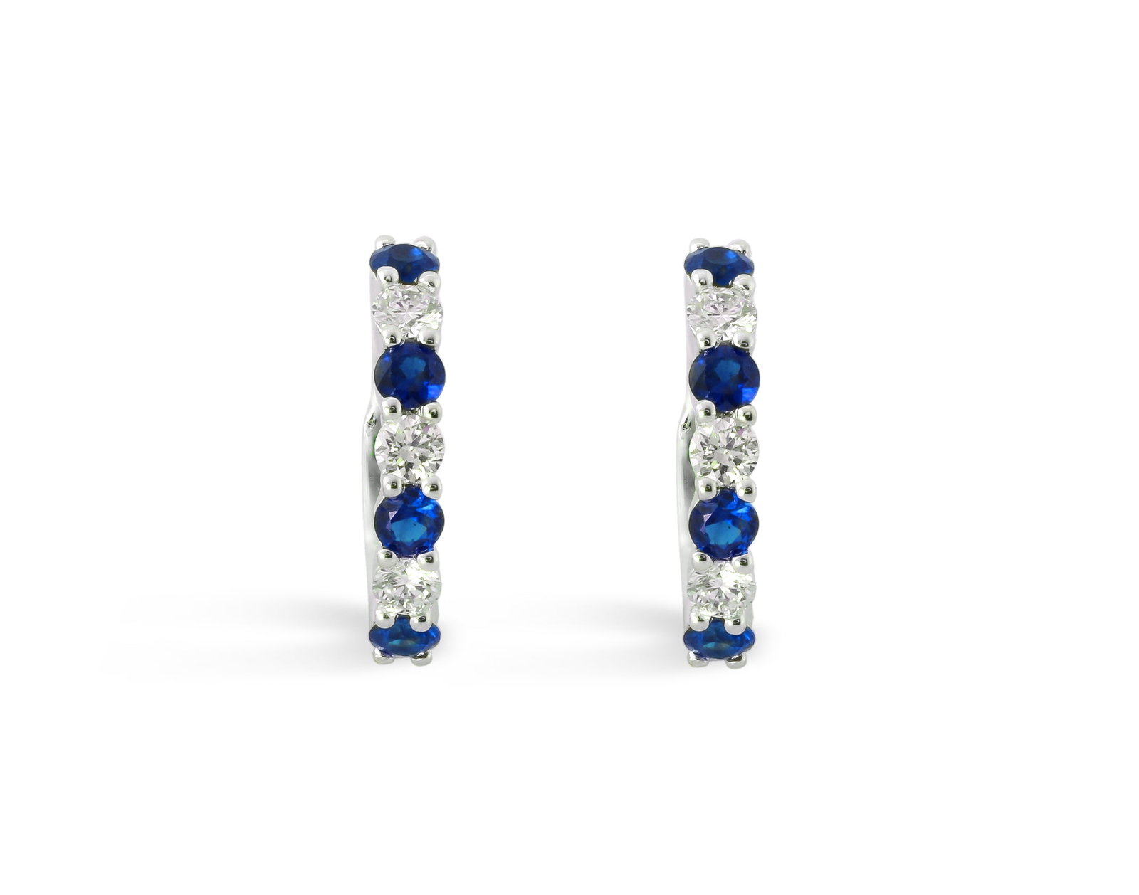 1.12ctw Blue Sapphire and Diamond 14K White Gold Huggies Earrings: Exuding opulence and grace, this elegant Alternating pair of earrings featuring Blue Sapphire, White Diamond is crafted for the distinguished. Showcasing the gems in a Hoop arrangement, the earrings c